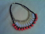 Choker with black thick leather cord, chain, tears and pom pom